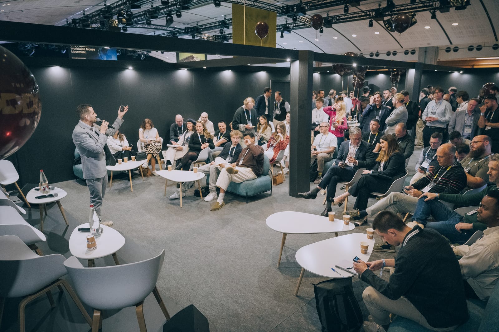 A More & More event in full flow, with a speaker addressing a packed room of founders and investors