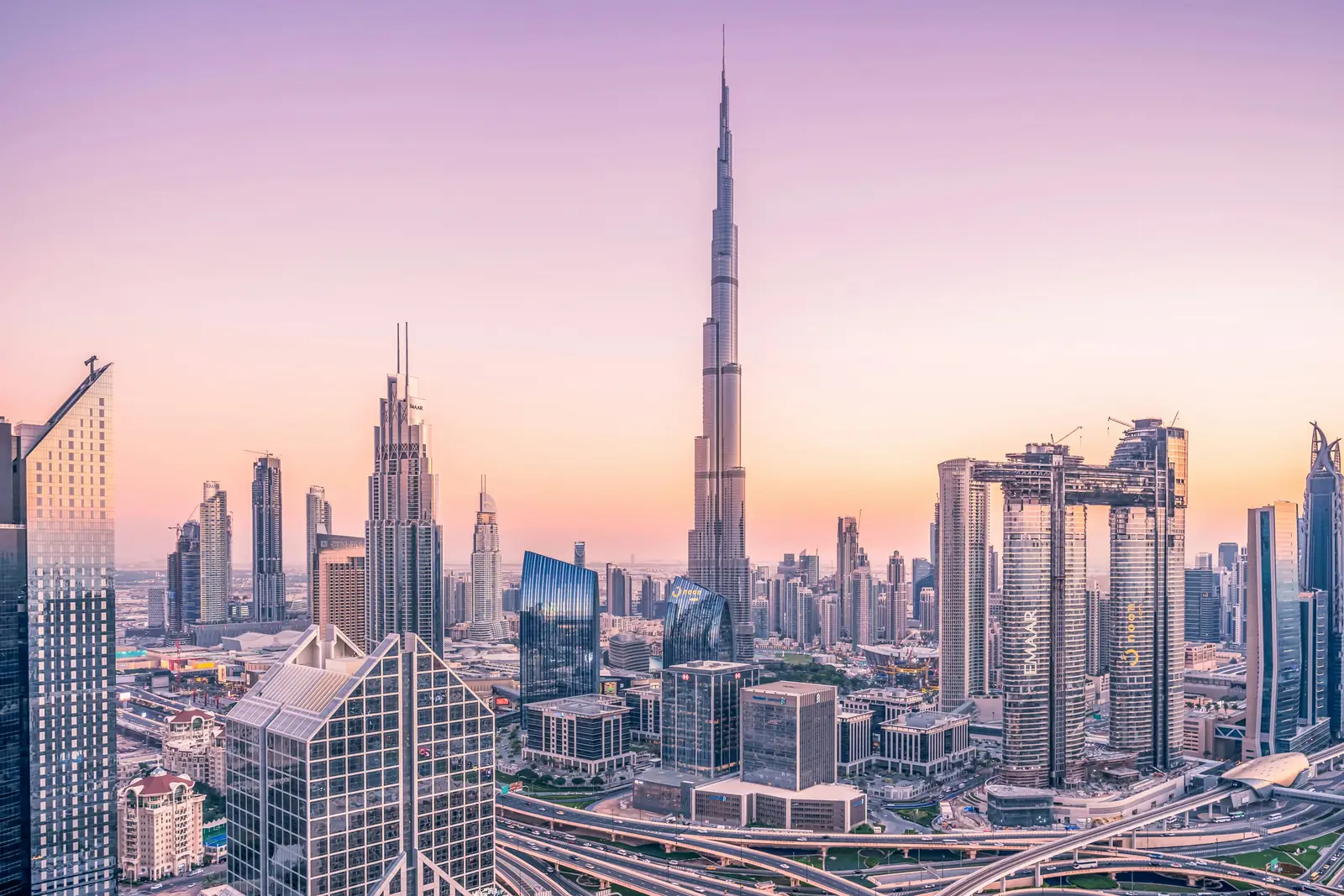 Downtown Dubai at dusk, the Burj Khalifa rising above the skyline