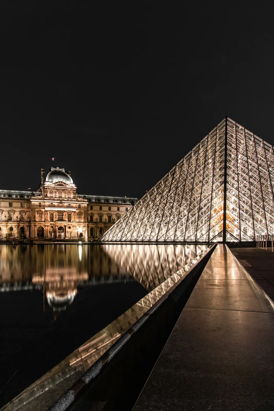 The Louvre pyramid in Paris, lit at night
