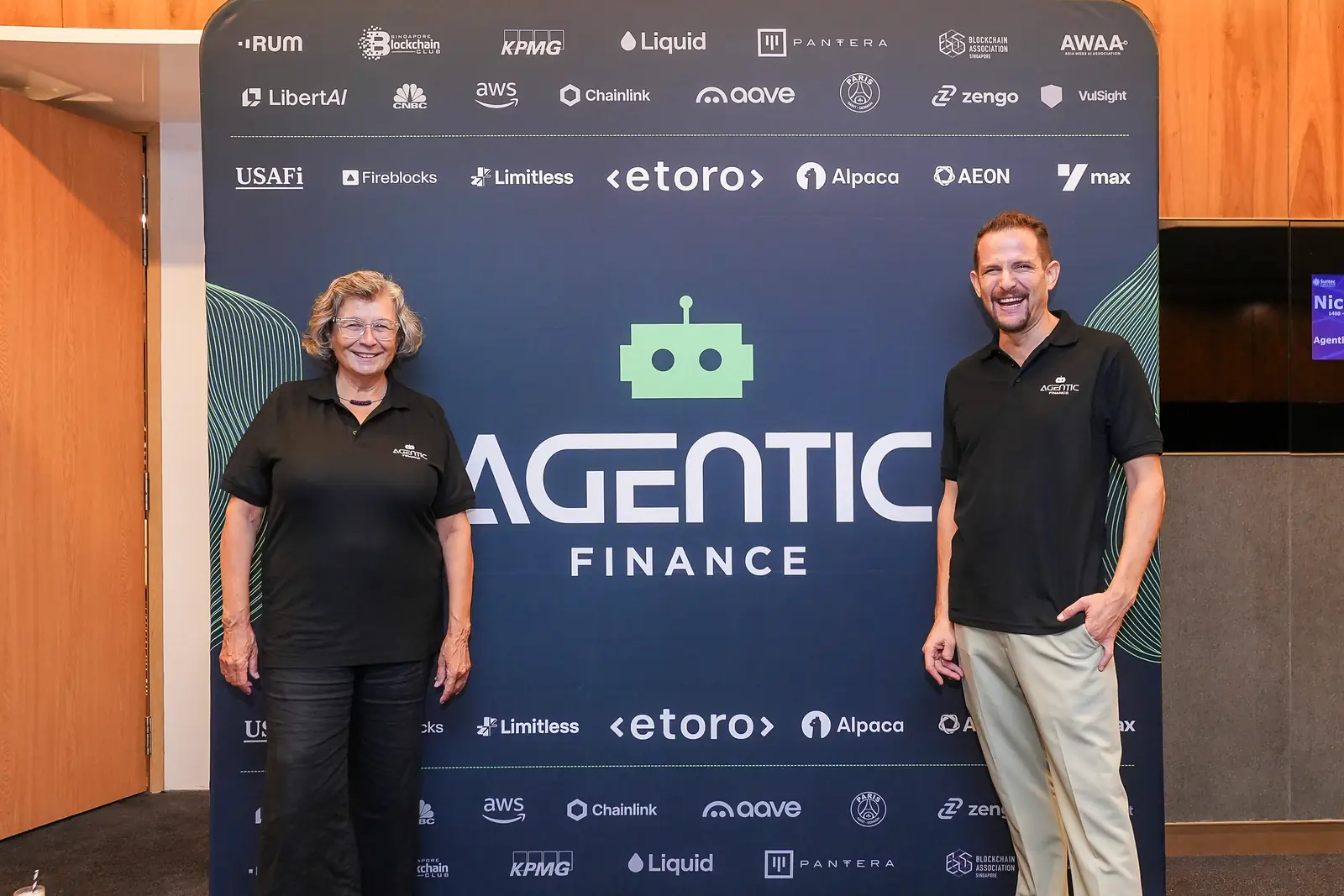 The Agentic Finance backdrop in Singapore, with eToro, Aave, Chainlink and the other partner marks