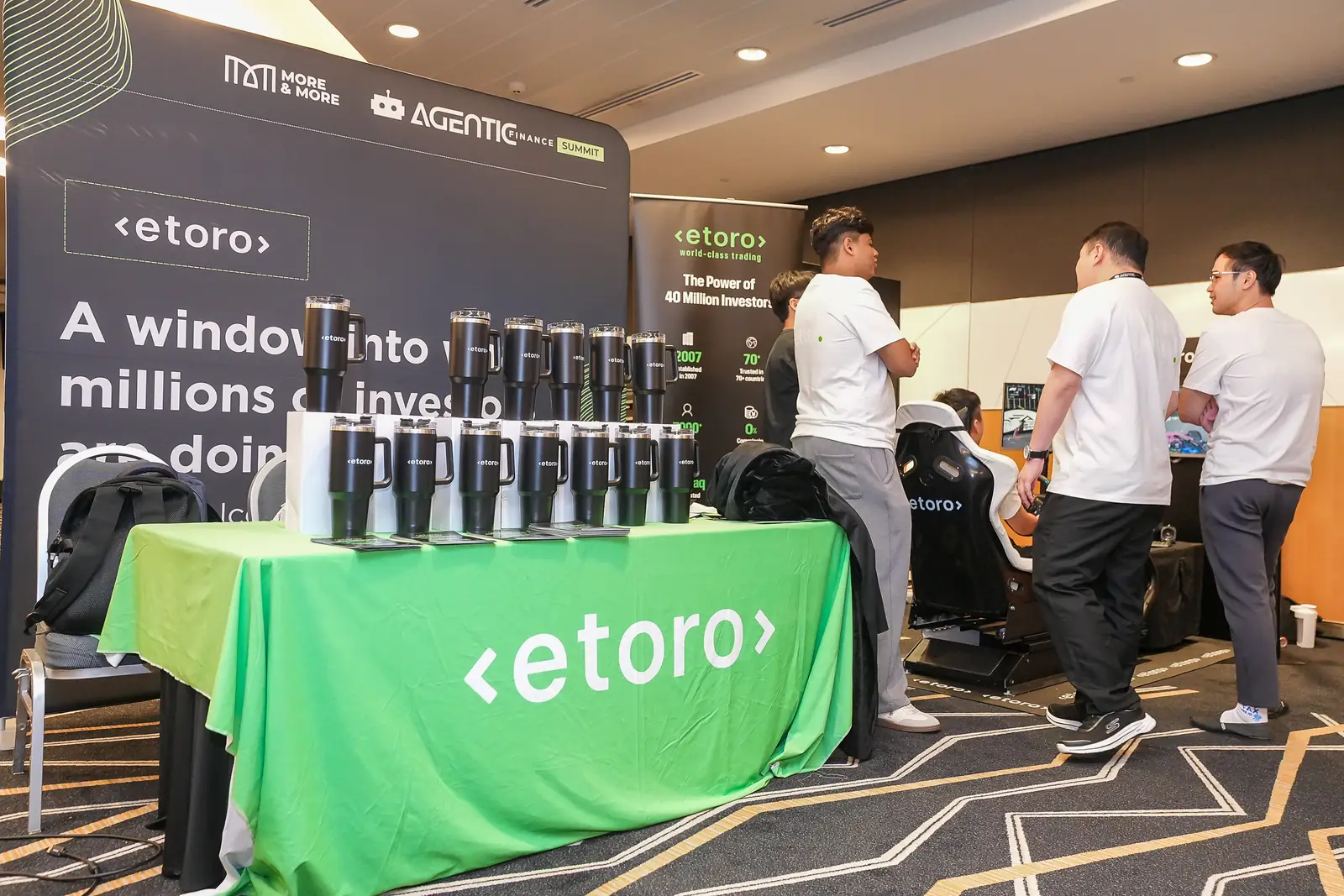 eToro’s branded table and giveaways at Agentic Finance Singapore
