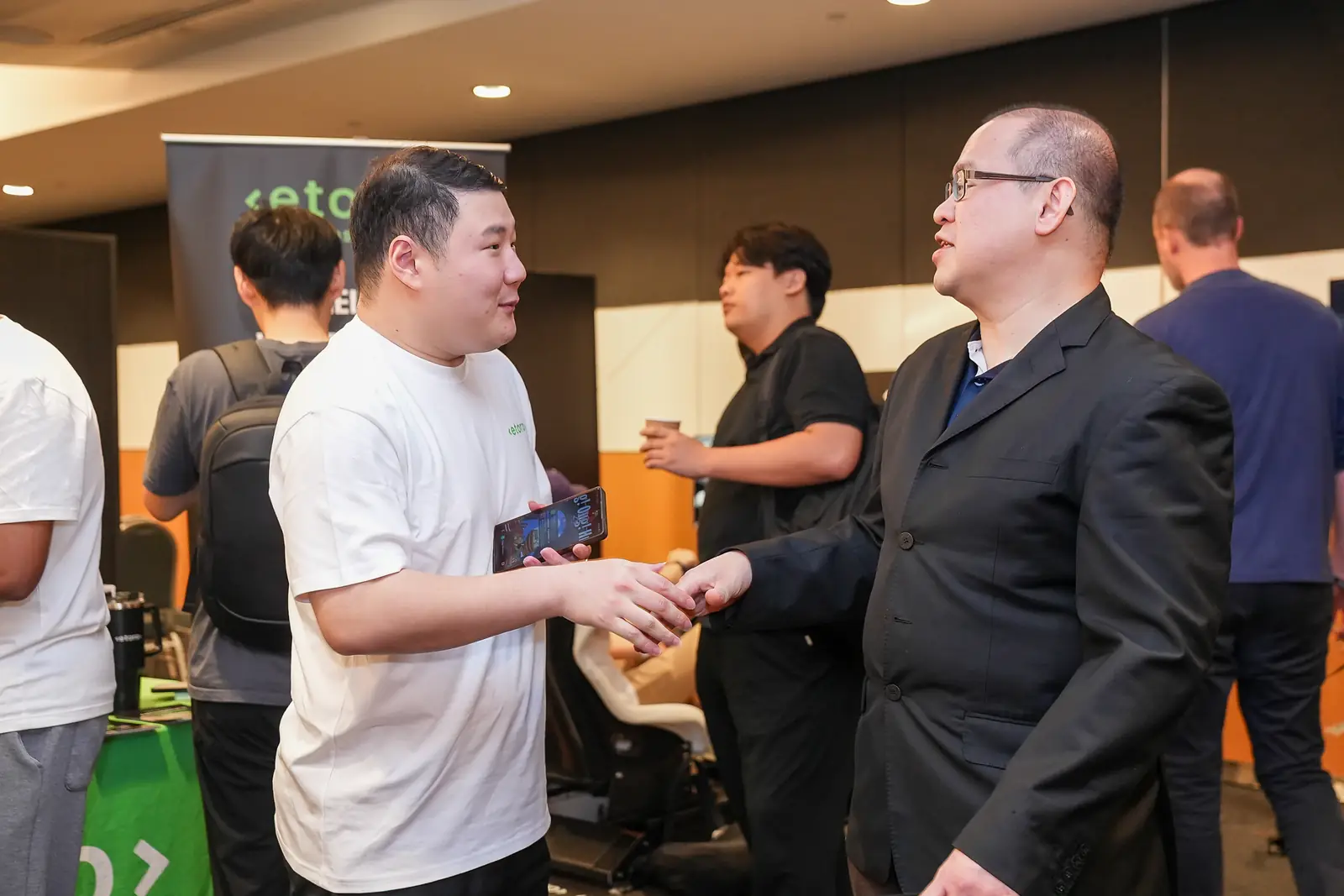 Guests meeting beside eToro’s stand in Singapore